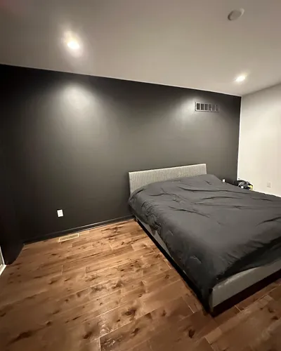 Dark charcoal accent wall in a Philadelphia bedroom